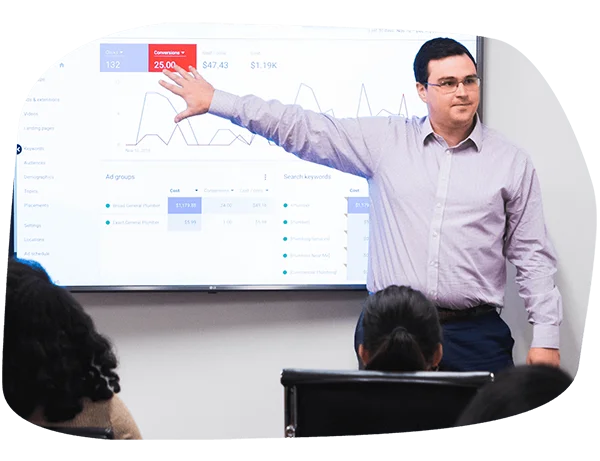 LYFE Marketing account manager presenting a digital marketing ROI report and social media growth metrics to a client during a strategy session.